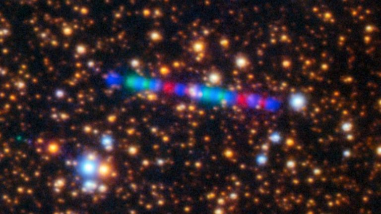 Comet IATLAS streaks across a dense star field